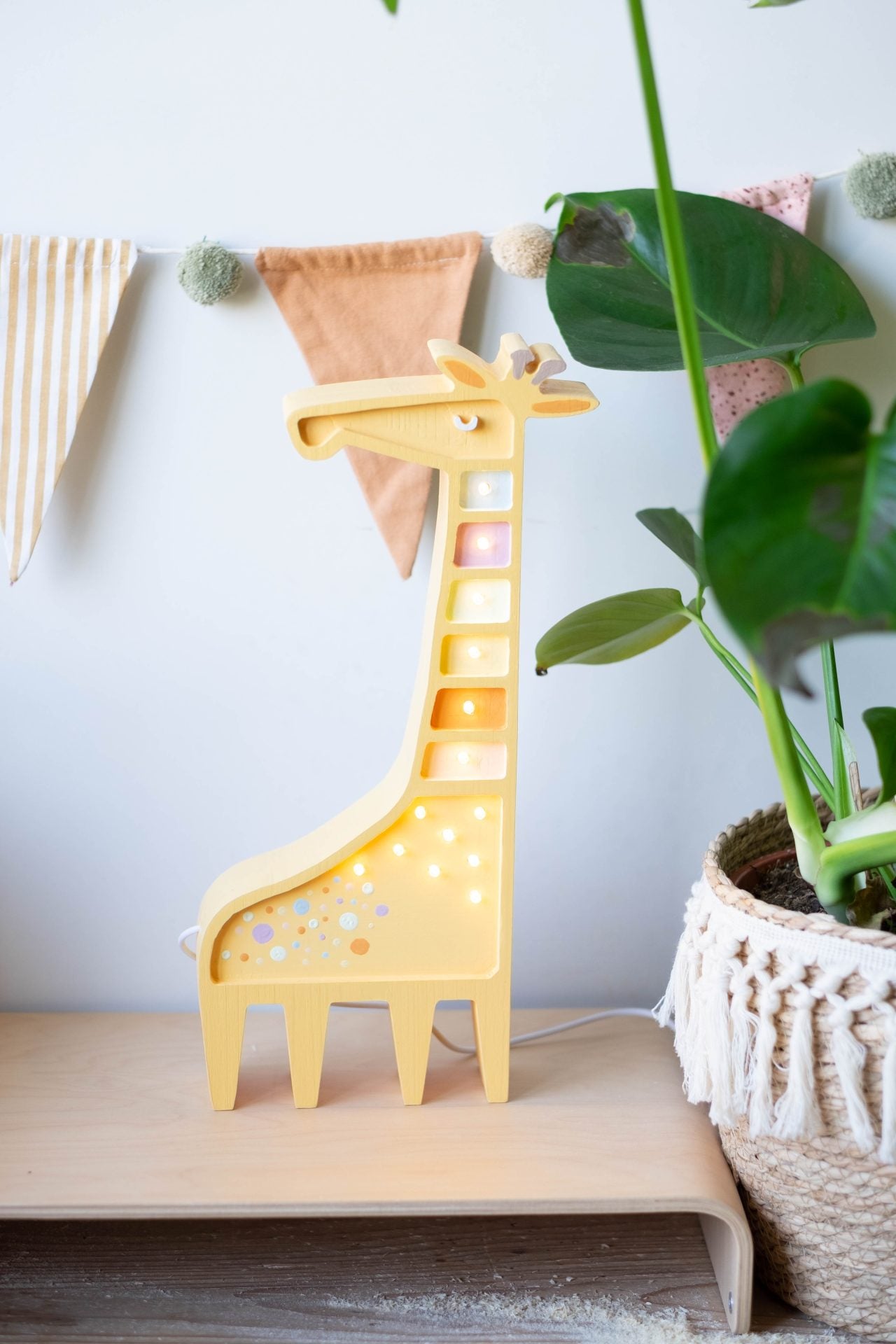 Giraffe-shaped lamp from Scandi Kids Concept Store, featuring a playful design with a soft, warm light for children's room decor.