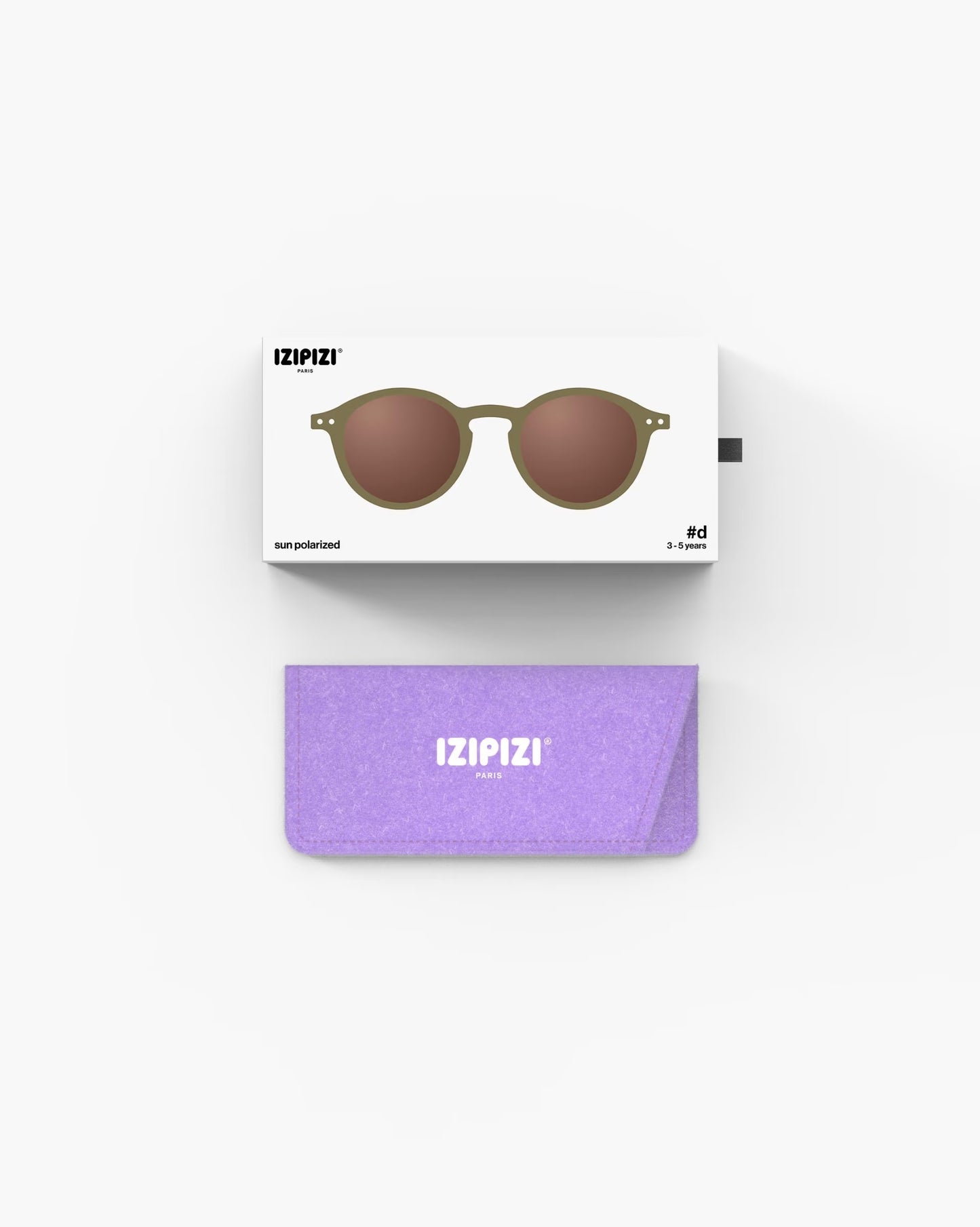 Children's IZIPIZI olive-colored sunglasses for ages 3-5, stylish and protective eyewear for kids in a natural outdoor setting.
