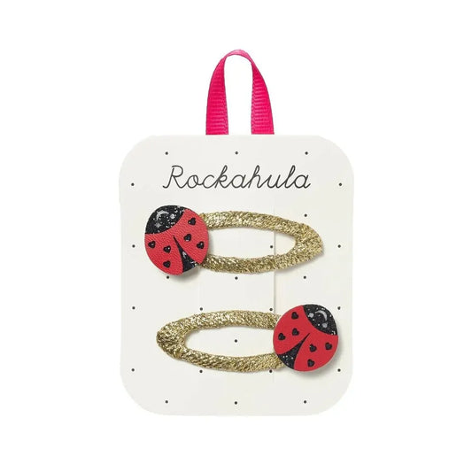 Red ladybug hair clips by Rockahula with black spots, perfect for adding a cute touch to children's hairstyles.