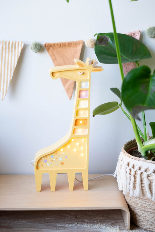 Giraffe-shaped lamp from Scandi Kids Concept Store, featuring a playful design with a soft, warm light for children's room decor.