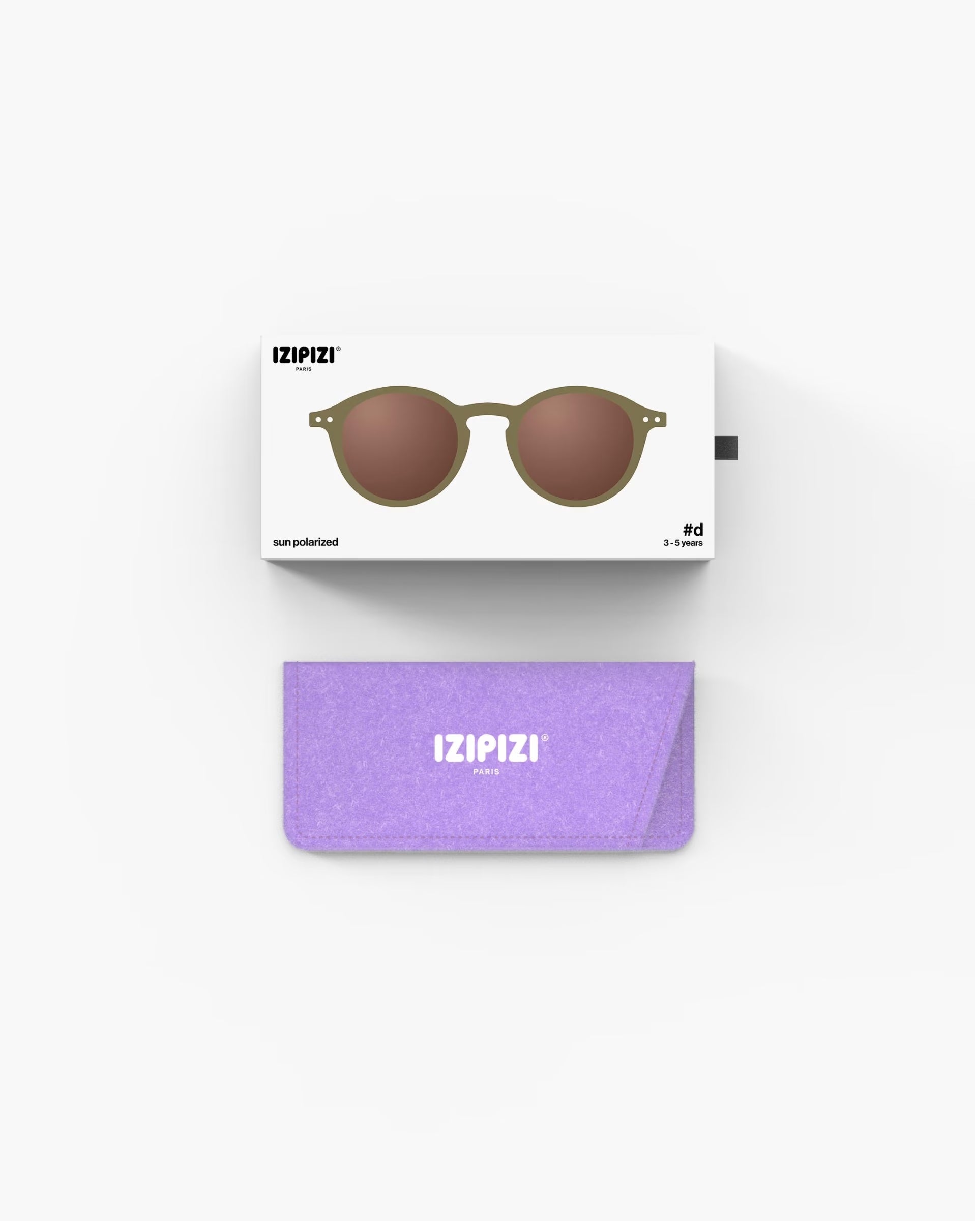 Children's IZIPIZI olive-colored sunglasses for ages 3-5, stylish and protective eyewear for kids in a natural outdoor setting.